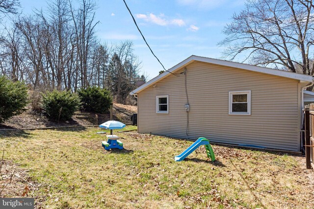 view of side of property with a yard