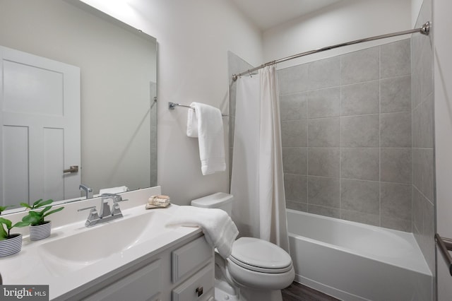 bathroom with toilet, shower / bath combo with shower curtain, and vanity