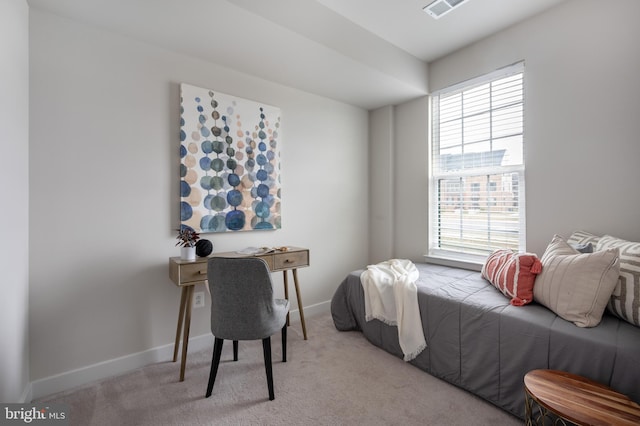 carpeted bedroom with visible vents and baseboards