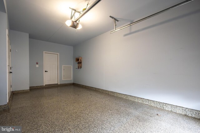 garage featuring baseboards and a garage door opener