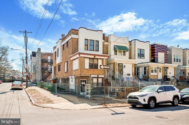 view of property with a fenced front yard and a residential view