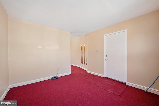 spare room featuring baseboards and carpet floors