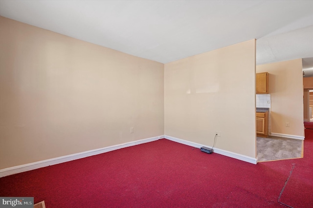 unfurnished room featuring baseboards and carpet floors