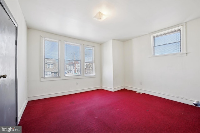 interior space with a closet, visible vents, baseboards, and carpet