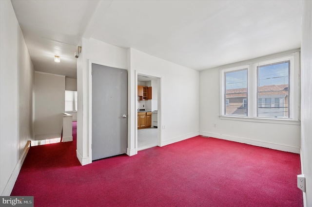 unfurnished bedroom with baseboards and dark colored carpet