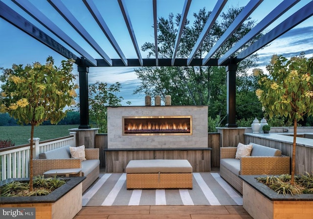 wooden terrace featuring an outdoor living space with a fireplace and a pergola