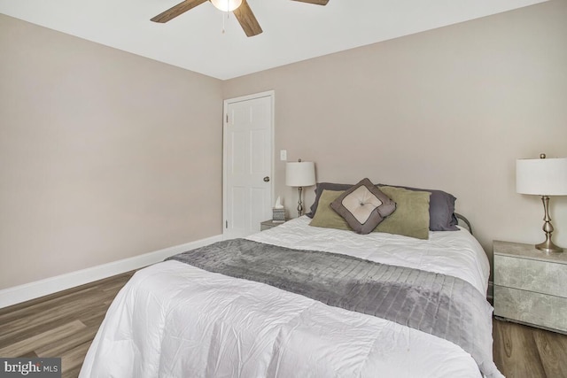 bedroom featuring a ceiling fan, baseboards, and wood finished floors