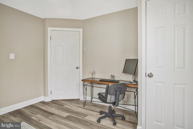 office space with baseboards and wood finished floors