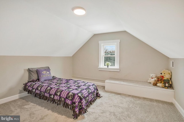 carpeted bedroom featuring lofted ceiling, visible vents, and baseboards