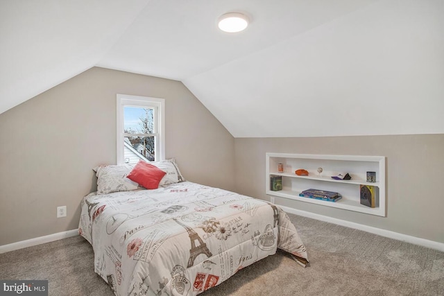 carpeted bedroom with vaulted ceiling and baseboards