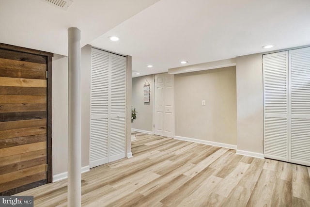 empty room with light wood finished floors, visible vents, baseboards, and recessed lighting