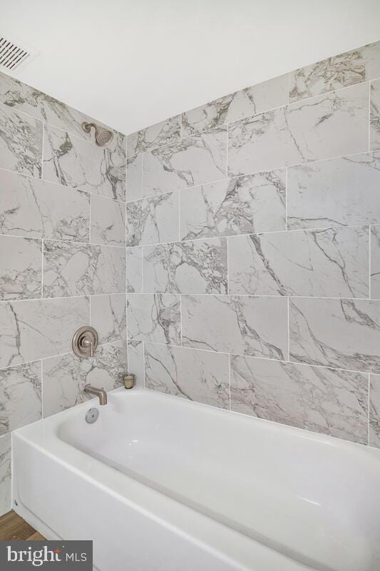 bathroom featuring visible vents and shower / bathing tub combination