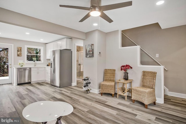 living area featuring recessed lighting, light wood-style flooring, and baseboards