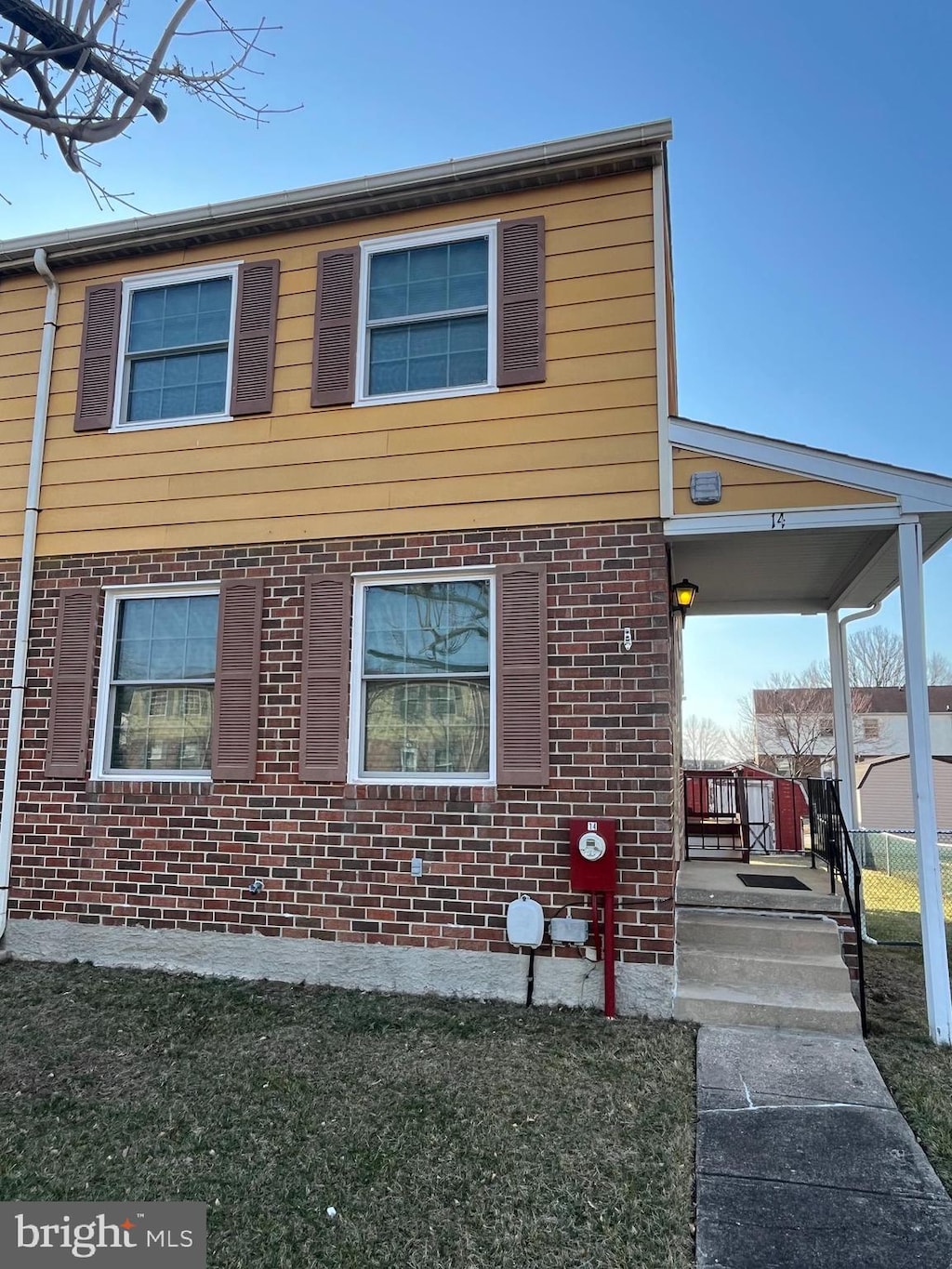 view of property exterior featuring covered porch and brick siding