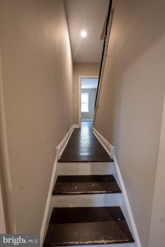 stairs featuring hardwood / wood-style floors, recessed lighting, and baseboards