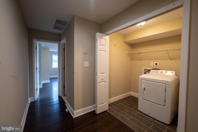 laundry room with laundry area, visible vents, baseboards, wood tiled floor, and washer / clothes dryer