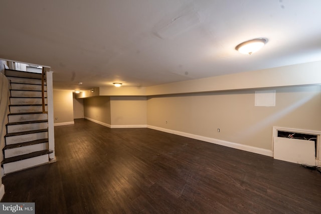 finished basement with stairway, wood finished floors, and baseboards