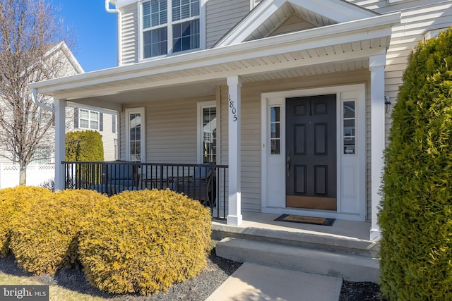 view of exterior entry with covered porch