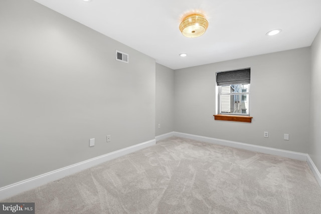 carpeted empty room featuring visible vents, baseboards, and recessed lighting