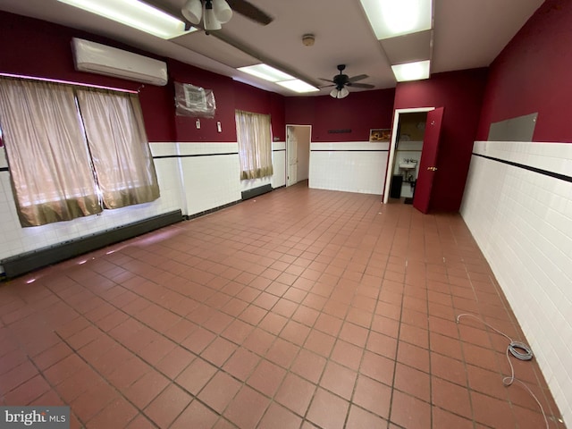 kitchen with wainscoting, tile walls, a wall mounted AC, and a ceiling fan