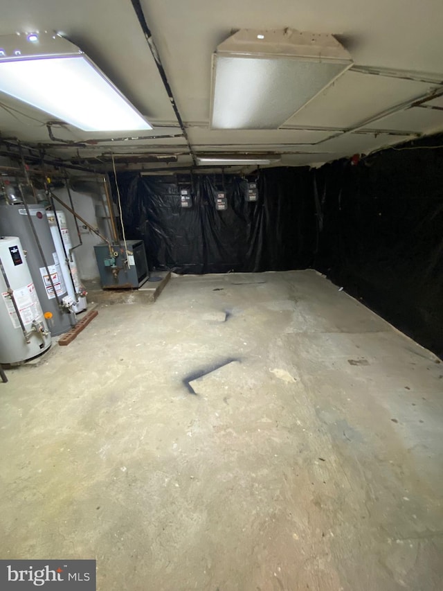 unfinished basement featuring water heater