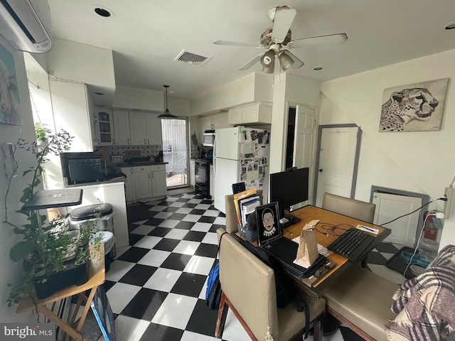 home office with visible vents, ceiling fan, and dark floors