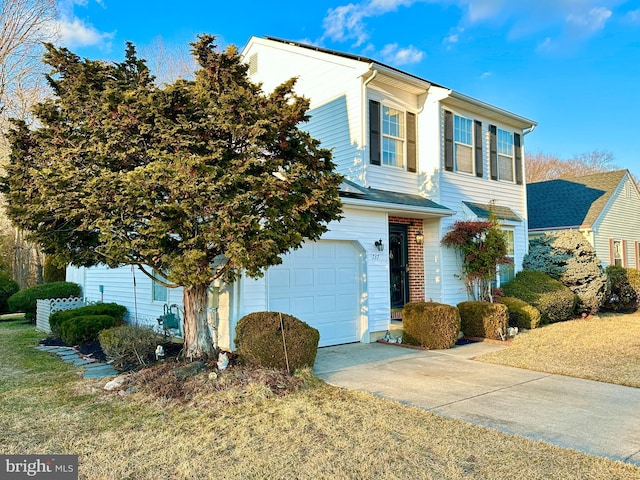 view of front facade with brick siding, an attached garage, and concrete driveway