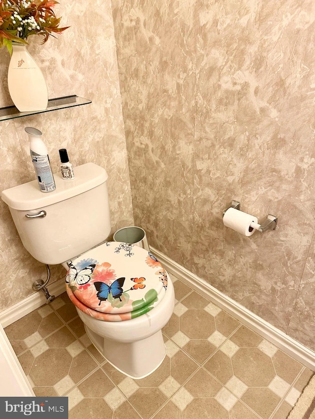 bathroom with toilet and baseboards