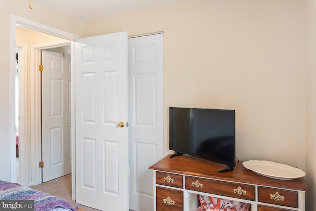 bedroom featuring light carpet