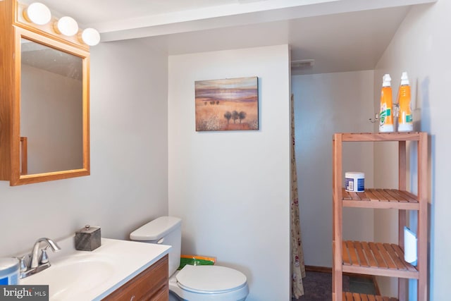 bathroom with vanity and toilet