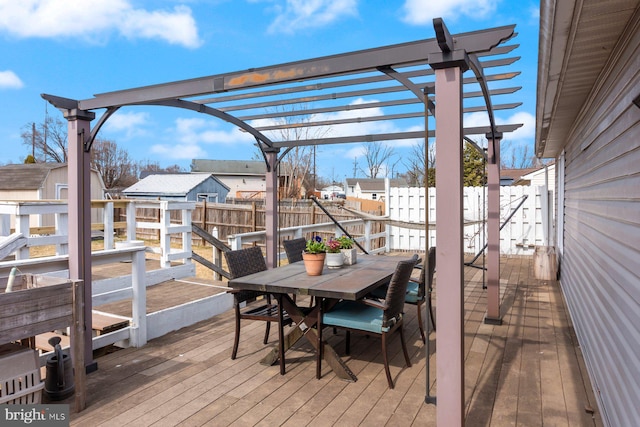 deck with outdoor dining space, fence, a pergola, and a residential view