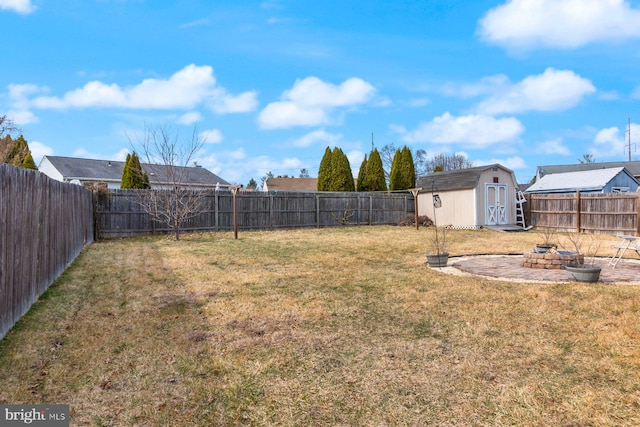 view of yard with a fenced backyard, an outdoor structure, and a shed