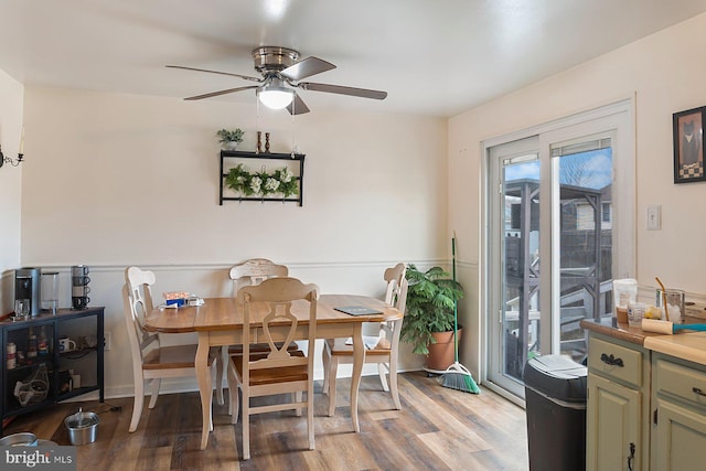 dining space featuring a ceiling fan and wood finished floors