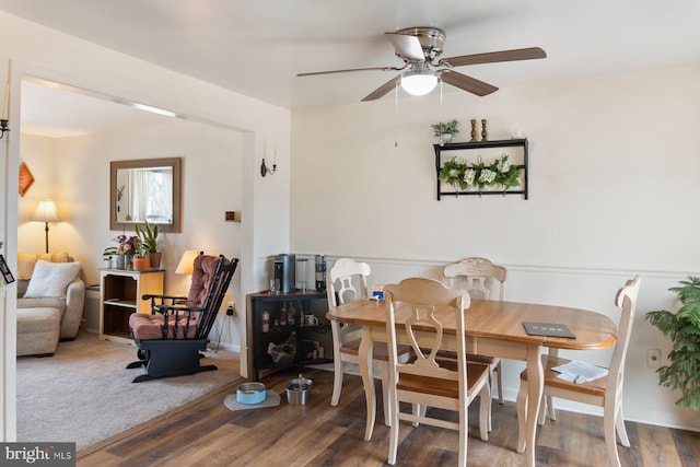 dining area with a ceiling fan and wood finished floors