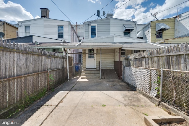 rear view of house featuring fence private yard