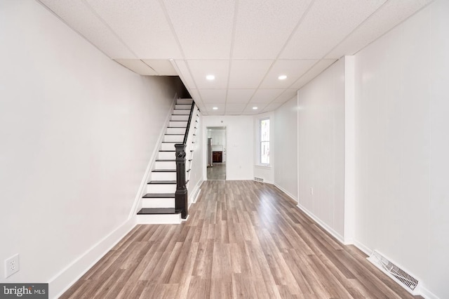 interior space featuring visible vents, stairs, baseboards, and wood finished floors