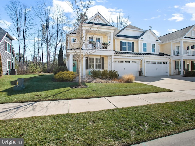 view of front of house with an attached garage, a balcony, central air condition unit, driveway, and a front lawn