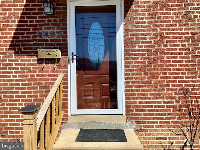 property entrance with brick siding