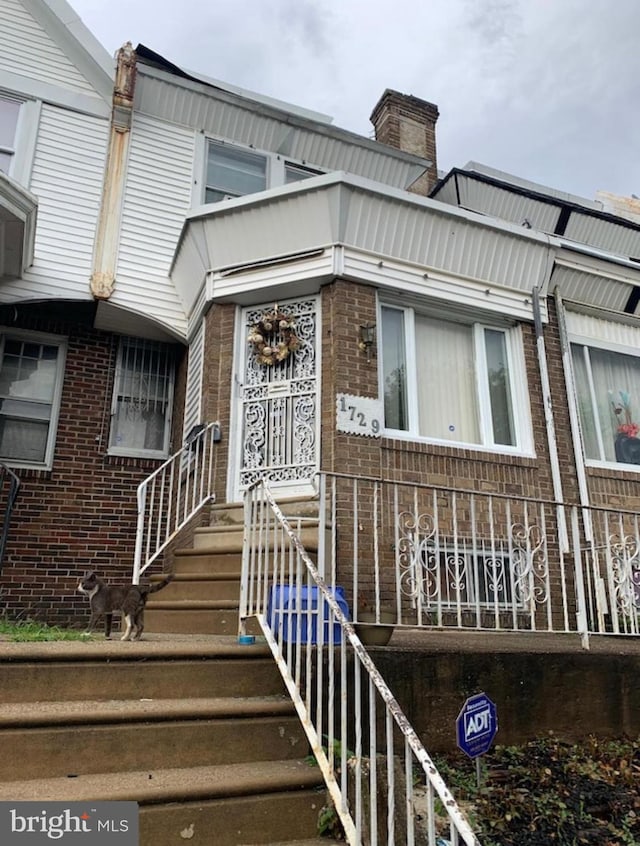 entrance to property with brick siding