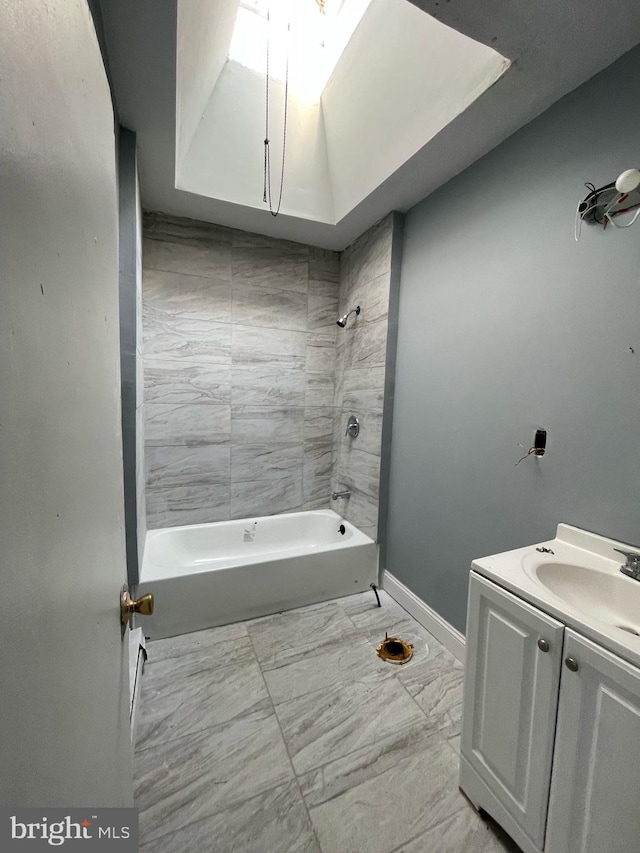 full bathroom with marble finish floor, vanity, shower / bathing tub combination, and baseboards