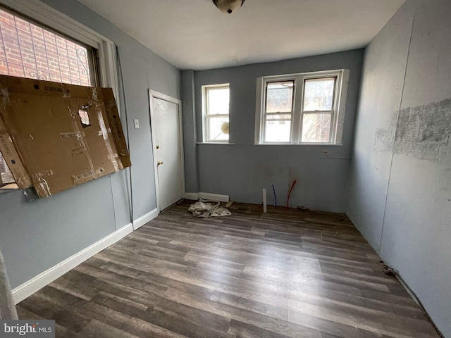 unfurnished room with wood finished floors