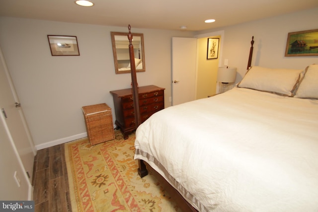 bedroom with recessed lighting, baseboards, and wood finished floors