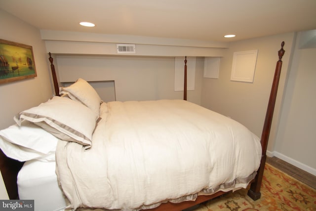 bedroom featuring recessed lighting, visible vents, baseboards, and wood finished floors