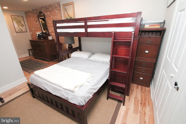 bedroom featuring light wood finished floors, recessed lighting, and baseboards