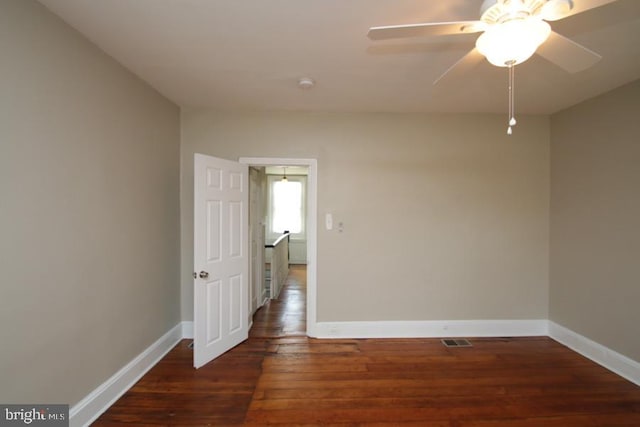 unfurnished room featuring visible vents, a ceiling fan, baseboards, and wood finished floors