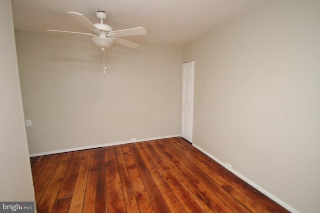 empty room with baseboards, a ceiling fan, and hardwood / wood-style flooring