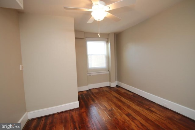 unfurnished room featuring ceiling fan, baseboards, and dark wood-style floors