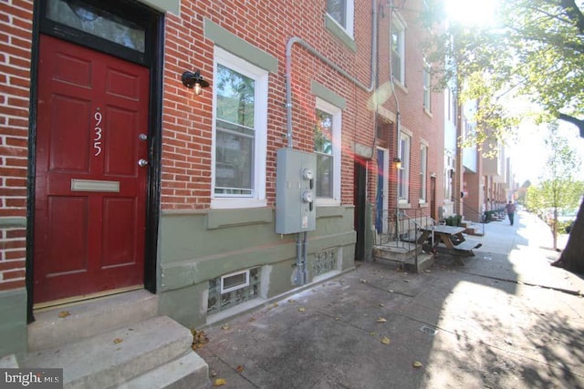 view of exterior entry with brick siding