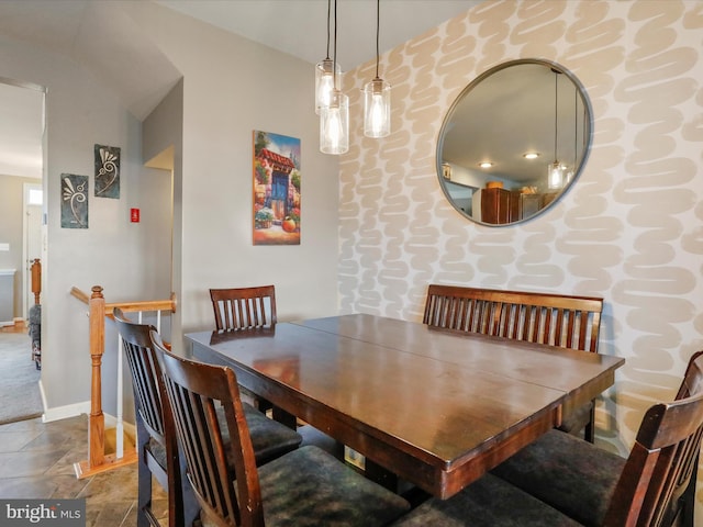 dining room with stone finish floor and baseboards