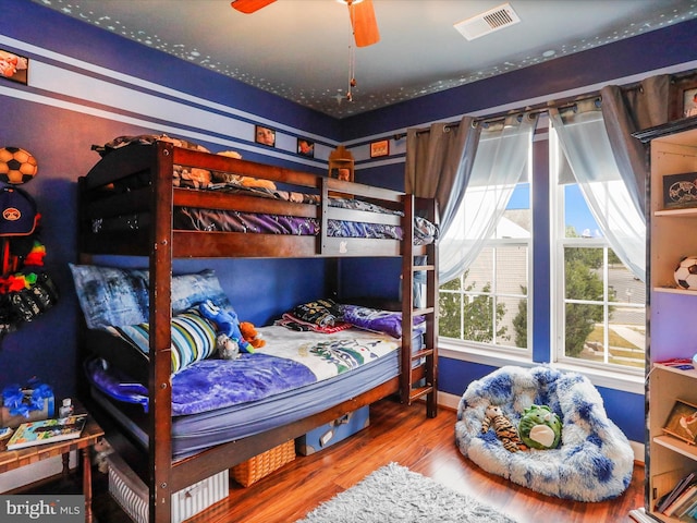 bedroom featuring wood finished floors and visible vents